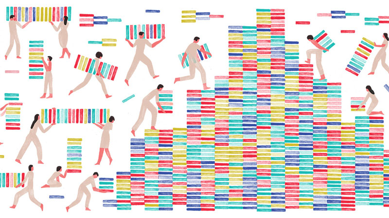 A team of students assemble a structure with blocks