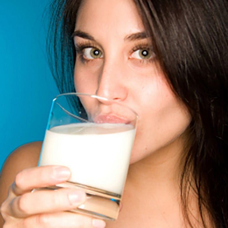 A woman drinking a glass of milk.