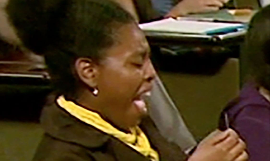 A woman reacting to a bitter taste.