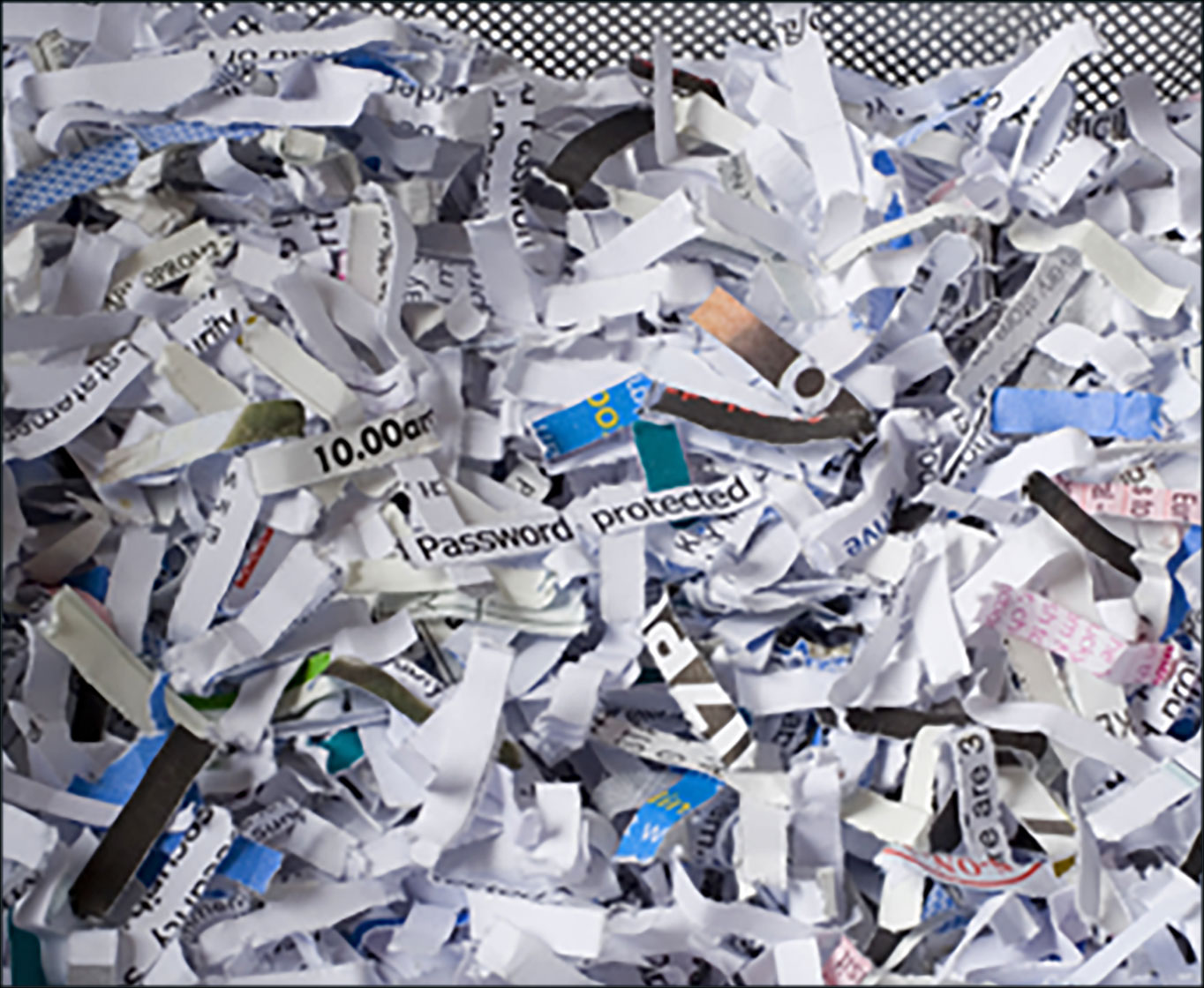 A pile of shredded paper with partially visible words and short phrases.