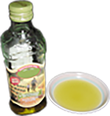A bottle of olive oil with an oil-filled dish.